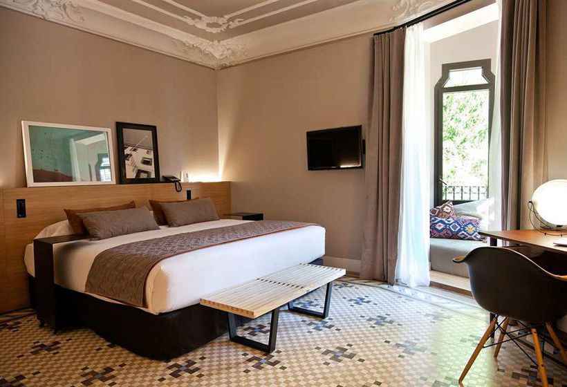 Boutique hotel room interior with a mosaic tile floor at the Alexandra Barcelona Hotel
