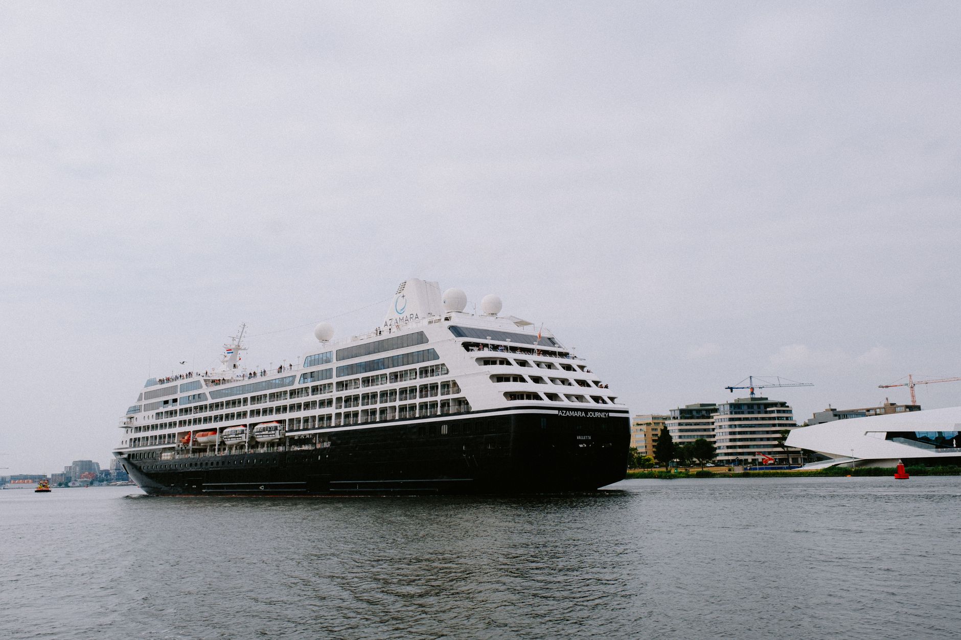 a large cruise ship is docked in a harbor