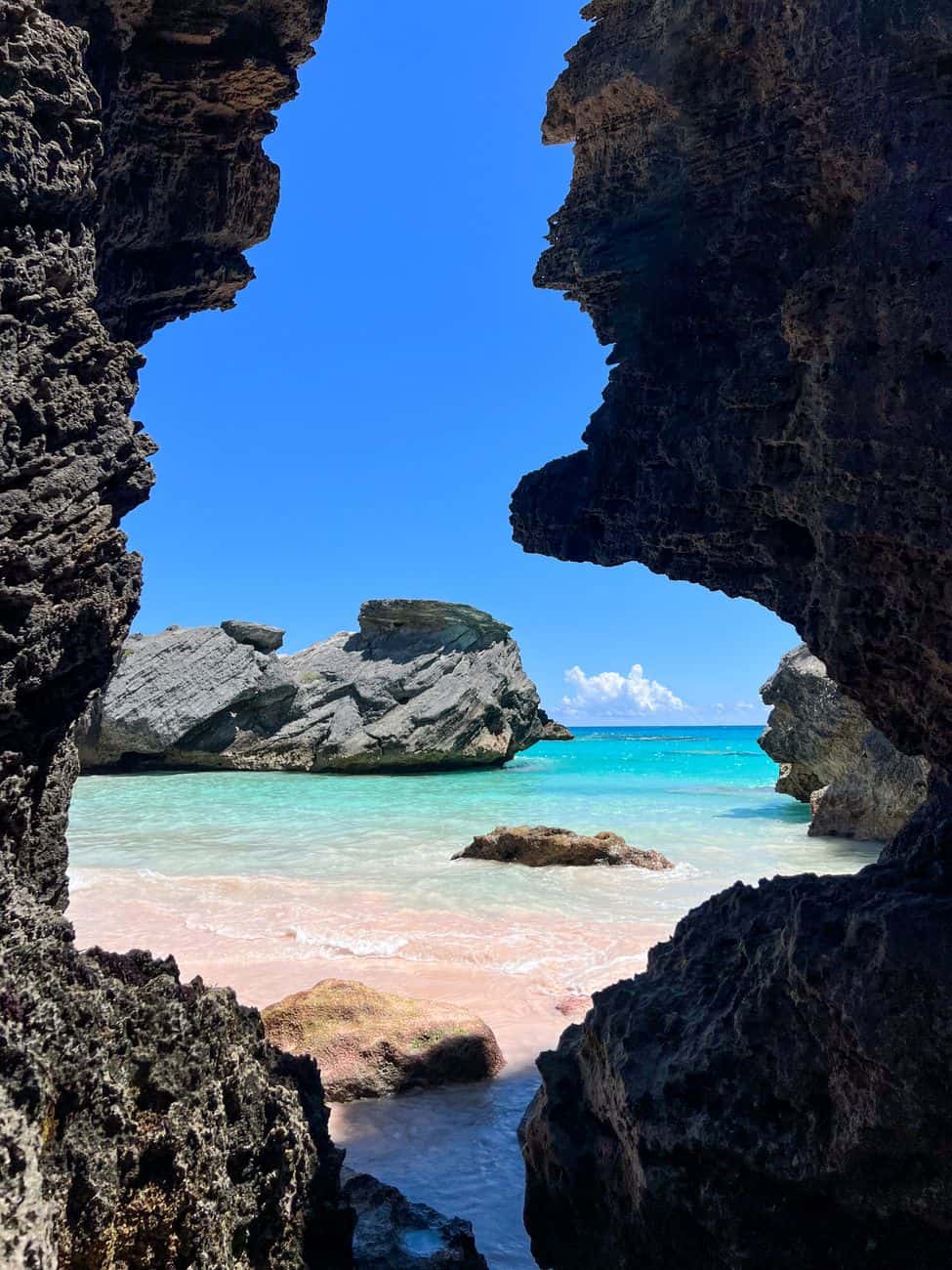 scenic bermuda beach through rocky cave