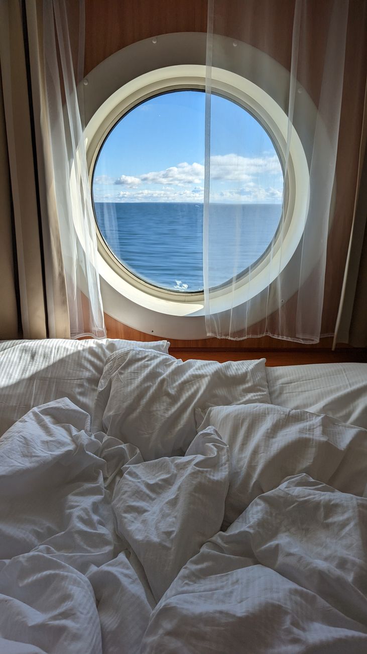 bed near window in cabin on vessel